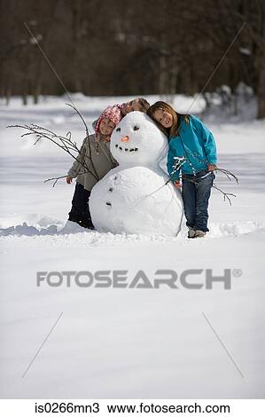 Girls with snowman View Large Photo Image Stock Image - Girls with snowman. Fotosearch