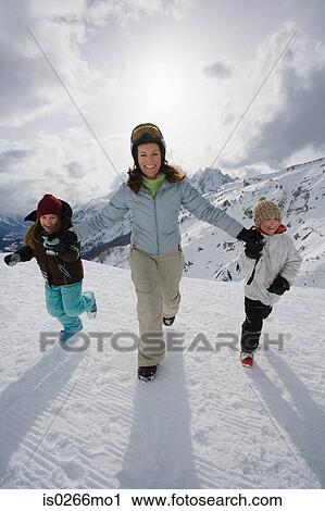 Stock Image - Mother and children in the snow. Fotosearch