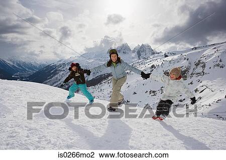Stock Image - Mother and children in the snow. Fotosearch