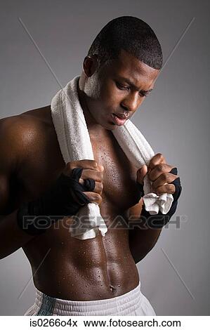 Stock Photo - Portrait of a man drying himself with a towel. Fotosearch