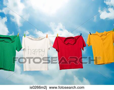 Tshirts hanging on a clothesline View Large Photo Image Stock Image - Tshirts hanging on a clothesline. Fotosearch