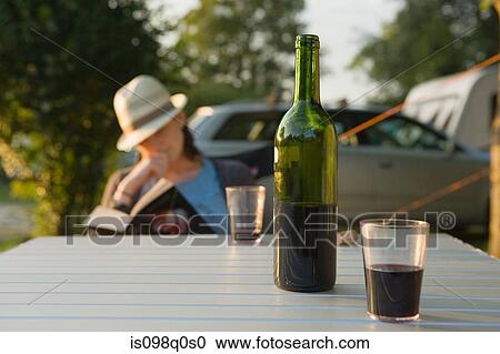 Stock Image - Wine and woman reading. Fotosearch