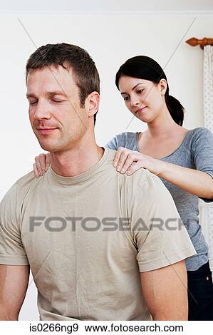 Woman massaging partner View Large Photo Image Stock Photo - Woman massaging partner. Fotosearch