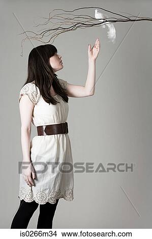 Woman reaching toward a branch View Large Photo Image Picture - Woman reaching toward a branch. Fotosearch