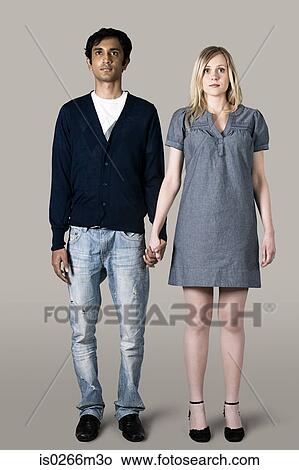 Young couple holding hands View Large Photo Image Picture - Young couple holding hands. Fotosearch