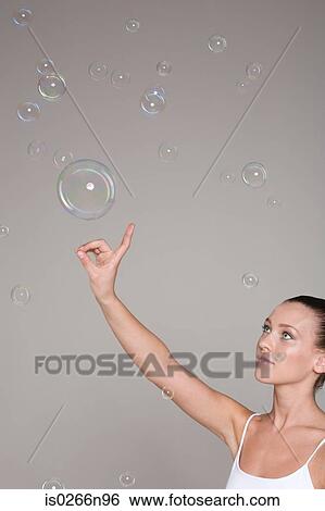 Young woman and bubbles View Large Photo Image Stock Photograph - Young woman and bubbles. Fotosearch
