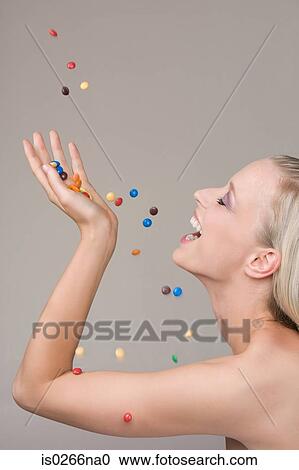Young woman and falling candy View Large Photo Image Stock Image - Young woman and falling candy. Fotosearch