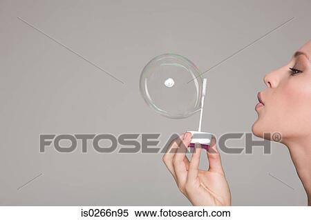 Young woman blowing a bubble View Large Photo Image Stock Photography - Young woman blowing a bubble. Fotosearch