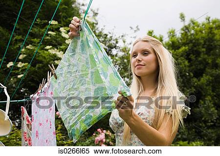 Young woman hanging laundry View Large Photo Image Stock Photography - Young woman hanging laundry. Fotosearch