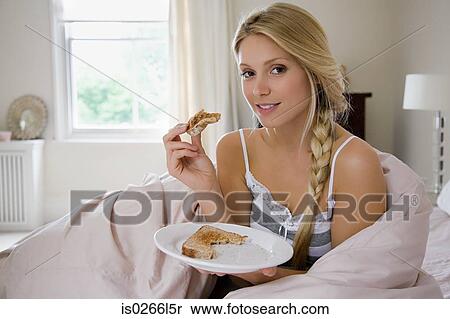Young woman having breakfast View Large Photo Image Stock Photography - Young woman having breakfast. Fotosearch