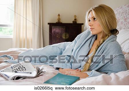Stock Photography - Young woman on bed. Fotosearch