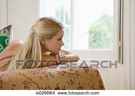 Young woman on sofa View Large Photo Image Picture - Young woman on sofa. Fotosearch