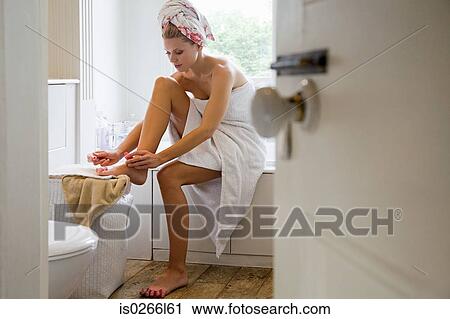 Young woman painting toenails View Large Photo Image Stock Image - Young woman painting toenails. Fotosearch