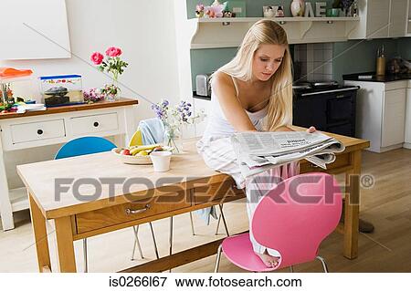 Young woman reading newspaper View Large Photo Image Stock Photo - Young woman reading newspaper. Fotosearch