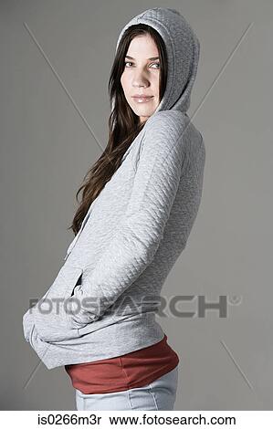 Young woman wearing a hoody View Large Photo Image Stock Photography - Young woman wearing a hoody. Fotosearch