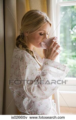 Stock Photo - Young woman with cup of tea. Fotosearch
