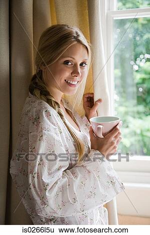 Stock Photograph - Young woman with cup of tea. Fotosearch