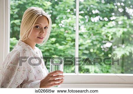 Stock Photo - Young woman with glass of water. Fotosearch