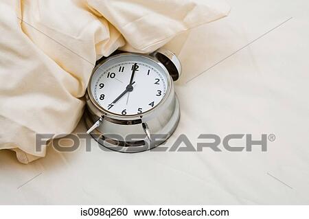 Alarm clock on bed View Large Photo Image Stock Image - Alarm clock on bed. Fotosearch