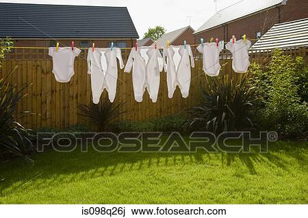 Stock Image - Baby clothes on clothes line. Fotosearch