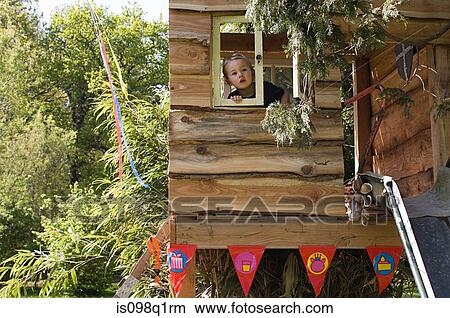 Boy in a treehouse View Large Photo Image Picture - Boy in a treehouse. Fotosearch