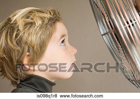 Boy looking at fan View Large Photo Image Stock Photo - Boy looking at fan. Fotosearch