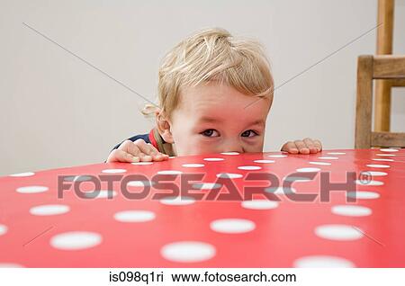 Boy looking over table View Large Photo Image Stock Image - Boy looking over table. Fotosearch