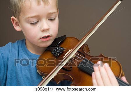 Stock Photo - Boy playing violin. Fotosearch