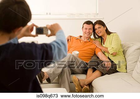 Boy taking picture of parents View Large Photo Image Stock Image - Boy taking picture of parents. Fotosearch