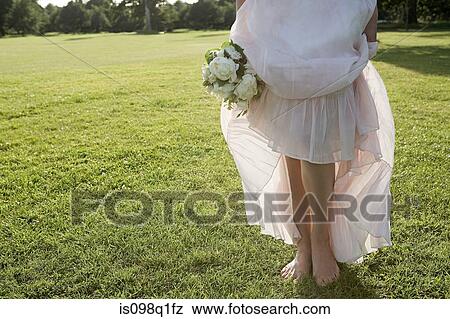 Bride standing on grass View Large Photo Image Stock Photo - Bride standing on grass. Fotosearch