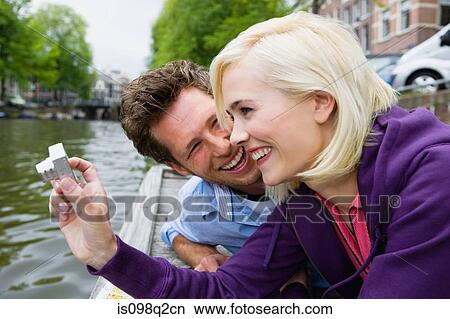 Couple by canal View Large Photo Image Picture - Couple by canal. Fotosearch
