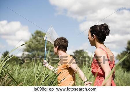 Couple in a field View Large Photo Image Stock Photography - Couple in a field. Fotosearch
