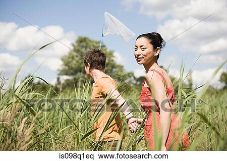 Couple in a field View Large Photo Image Stock Photography - Couple in a field. Fotosearch