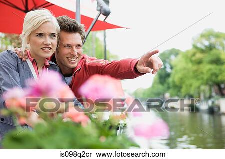 Stock Photography - Couple looking at view on canal. Fotosearch