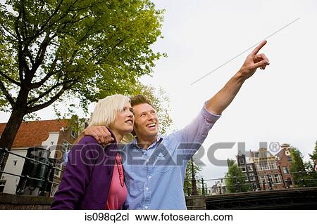 Stock Image - Couple looking up. Fotosearch