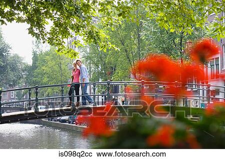 Stock Image - Couple on a bridge. Fotosearch