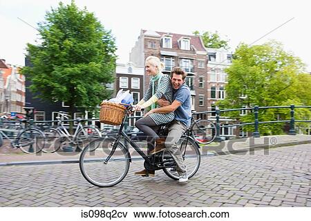Couple on bicycle View Large Photo Image Stock Photo - Couple on bicycle. Fotosearch