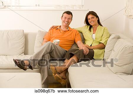 Stock Image - Couple on sofa. Fotosearch
