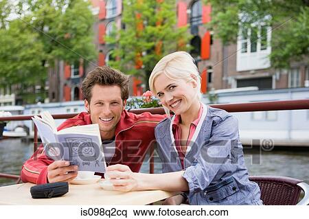 Stock Photography - Couple with guidebook. Fotosearch