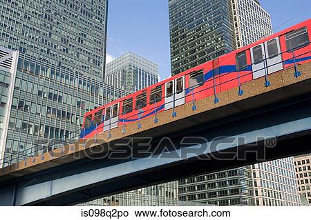 Picture - DLR train passing through canary wharf. Fotosearch
