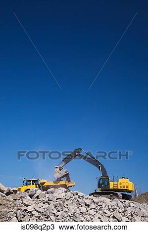 Excavator on piles of rubble View Large Photo Image Stock Image - Excavator on piles of rubble. Fotosearch
