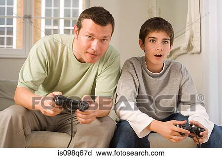 Father and son playing video game View Large Photo Image Stock Image - Father and son playing video game. Fotosearch
