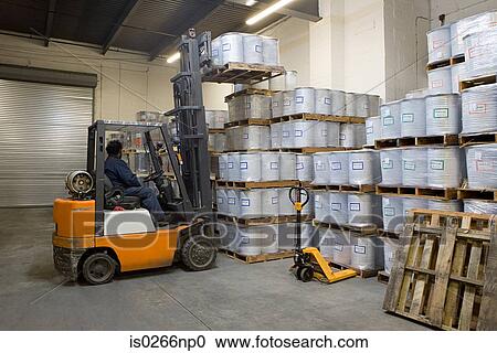 Fork lift driver lifting pallets View Large Photo Image Stock Image - Fork lift driver lifting pallets. Fotosearch