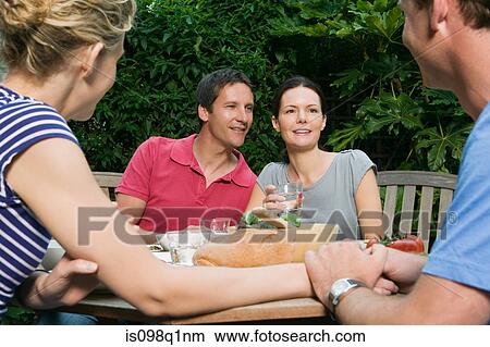 Picture - Friends having outdoor meal. Fotosearch