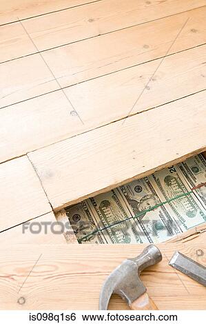 Stock Photograph - Hidden money under floorboards. Fotosearch