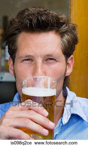 Stock Image - Man drinking beer. Fotosearch