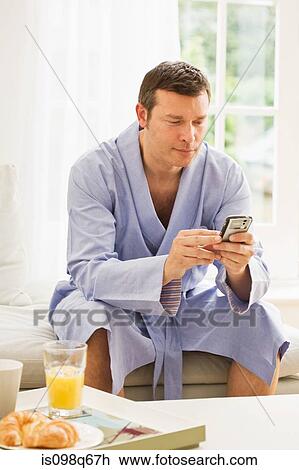 Man looking at cellphone View Large Photo Image Stock Image - Man looking at cellphone. Fotosearch