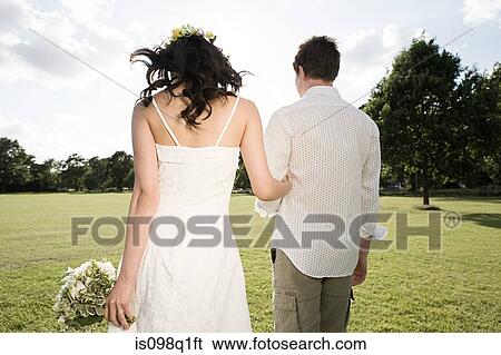 Stock Photograph - Newlyweds outdoors. Fotosearch