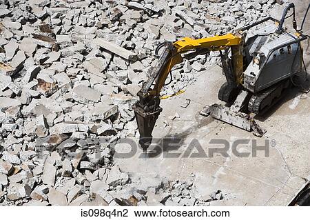 Stock Image - Pneumatic drill breaking concrete. Fotosearch