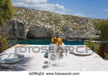 Stock Image - Restaurant table by the sea. Fotosearch